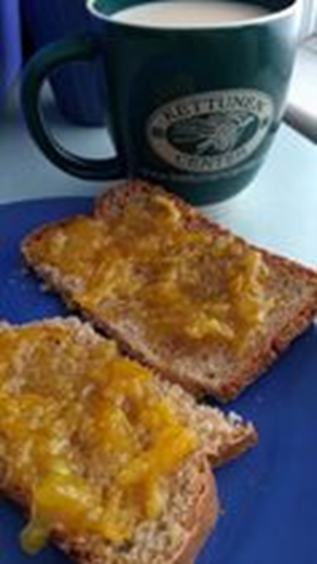 Toast on a blue plate with a green coffee cup. 